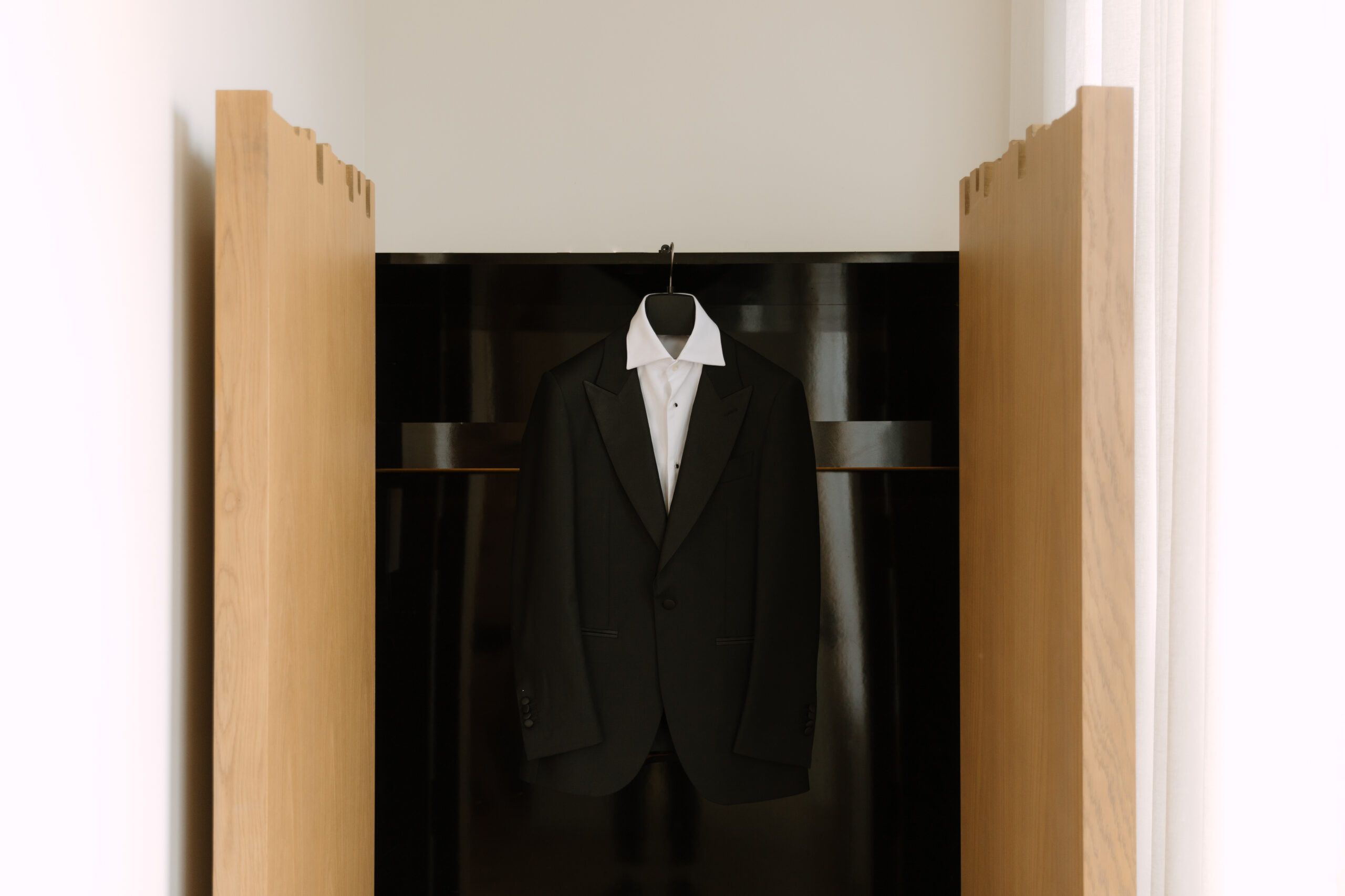 black tux hanging in open wardrobe at Kimpton La Peer Hotel