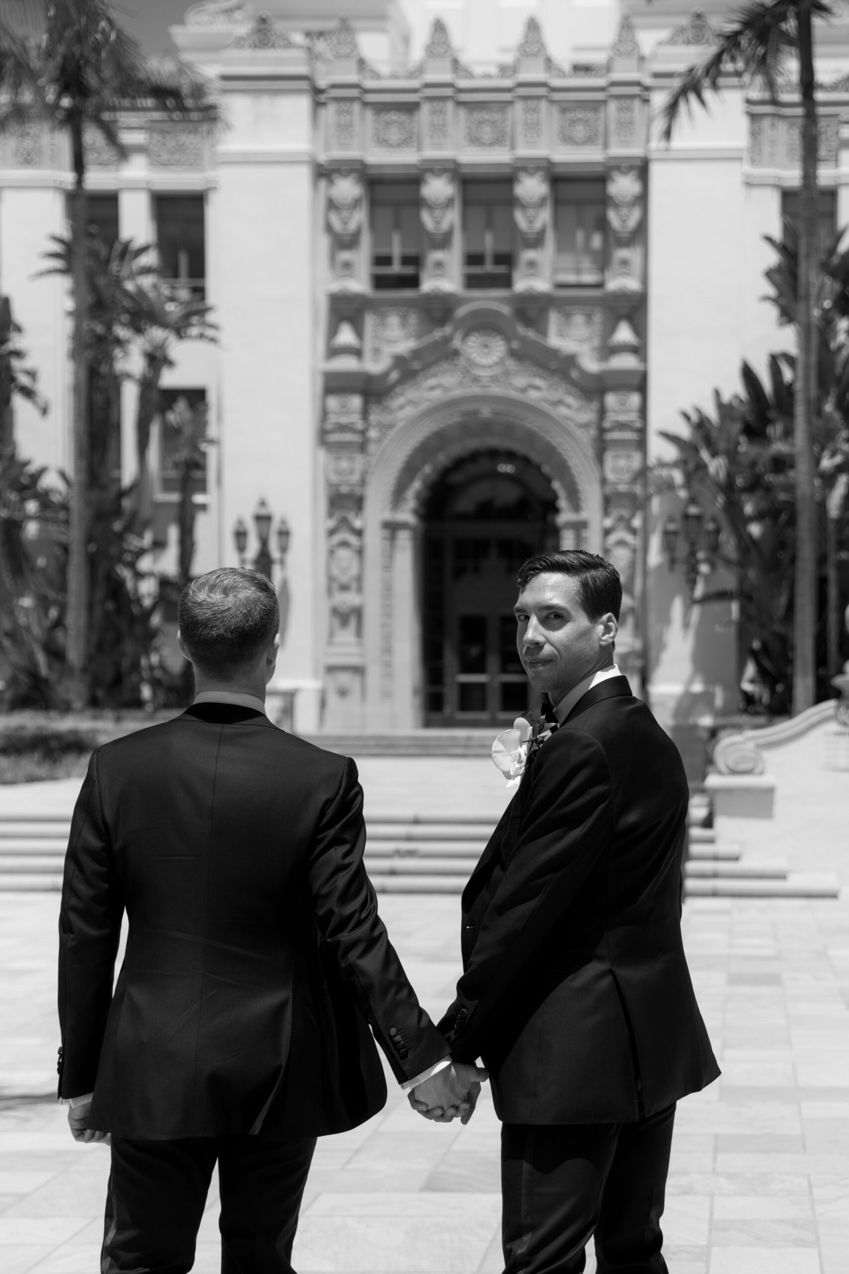 black and white photo of gay couple walking toward Beverly Hills City Hall