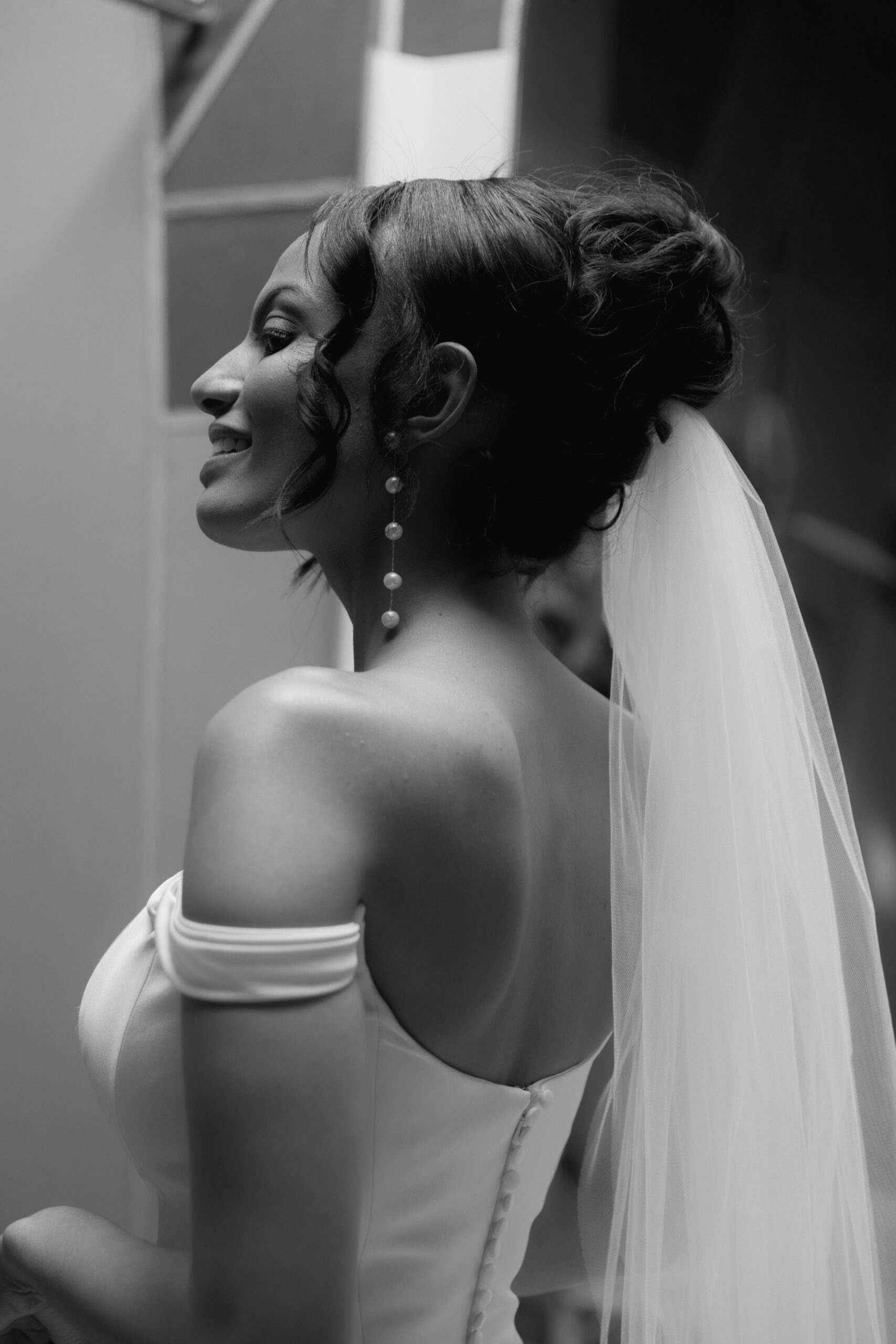 close up black and white photo of Black bride's side profile looking at her mom before wedding ceremony