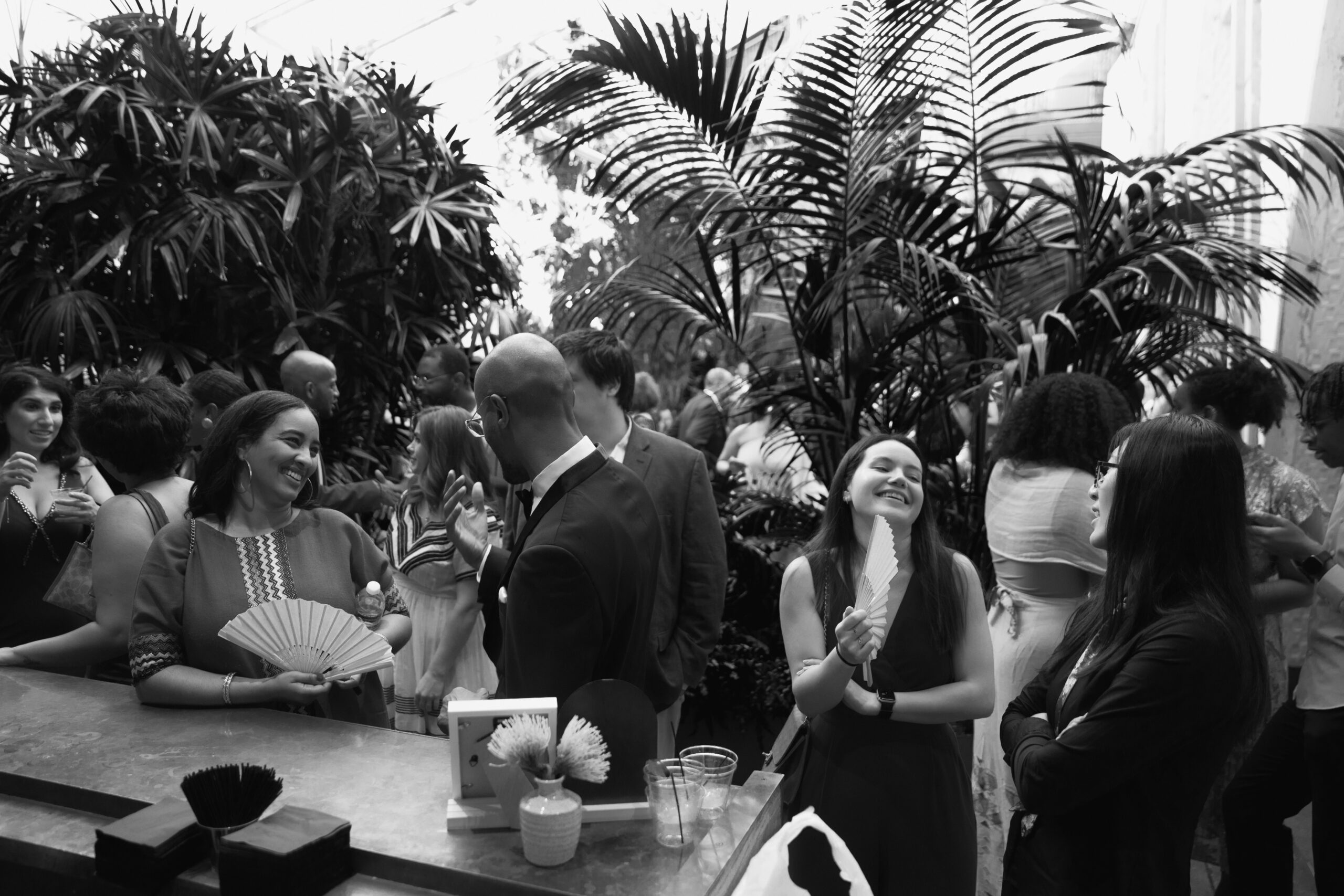 black and white photo of guests mingling during cocktail hour at Grass Room DTLA