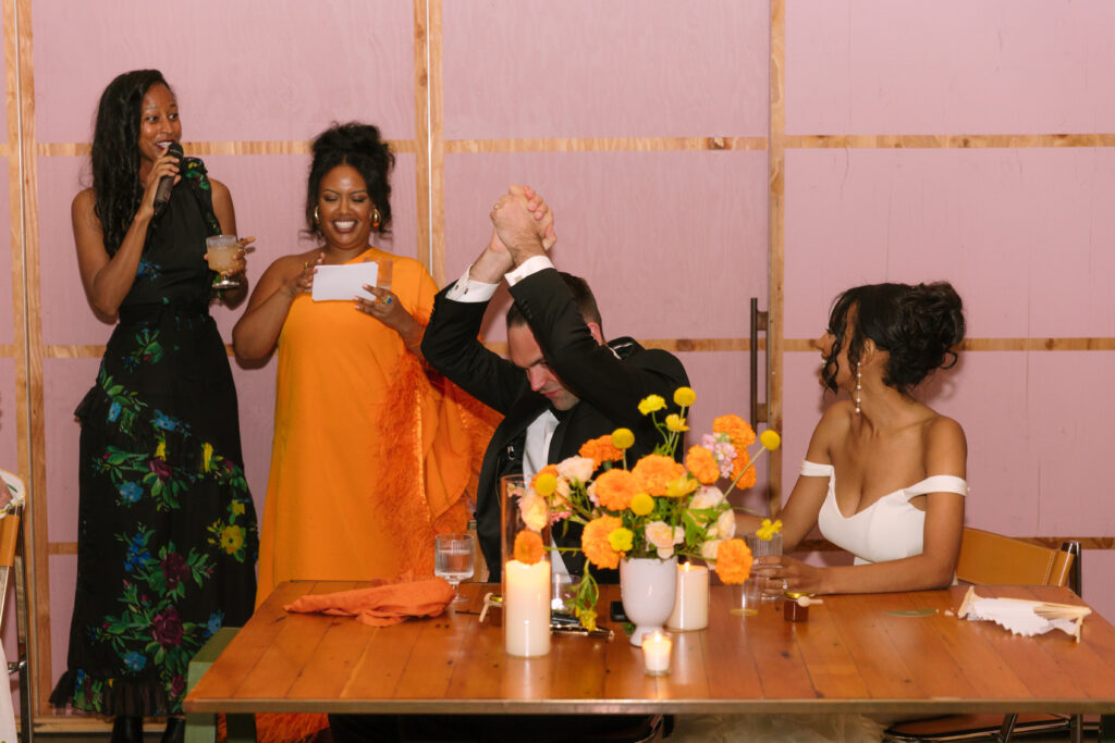 groom congratulates himself as bride's best friends give toast to them during wedding reception at Grass Room DTLA