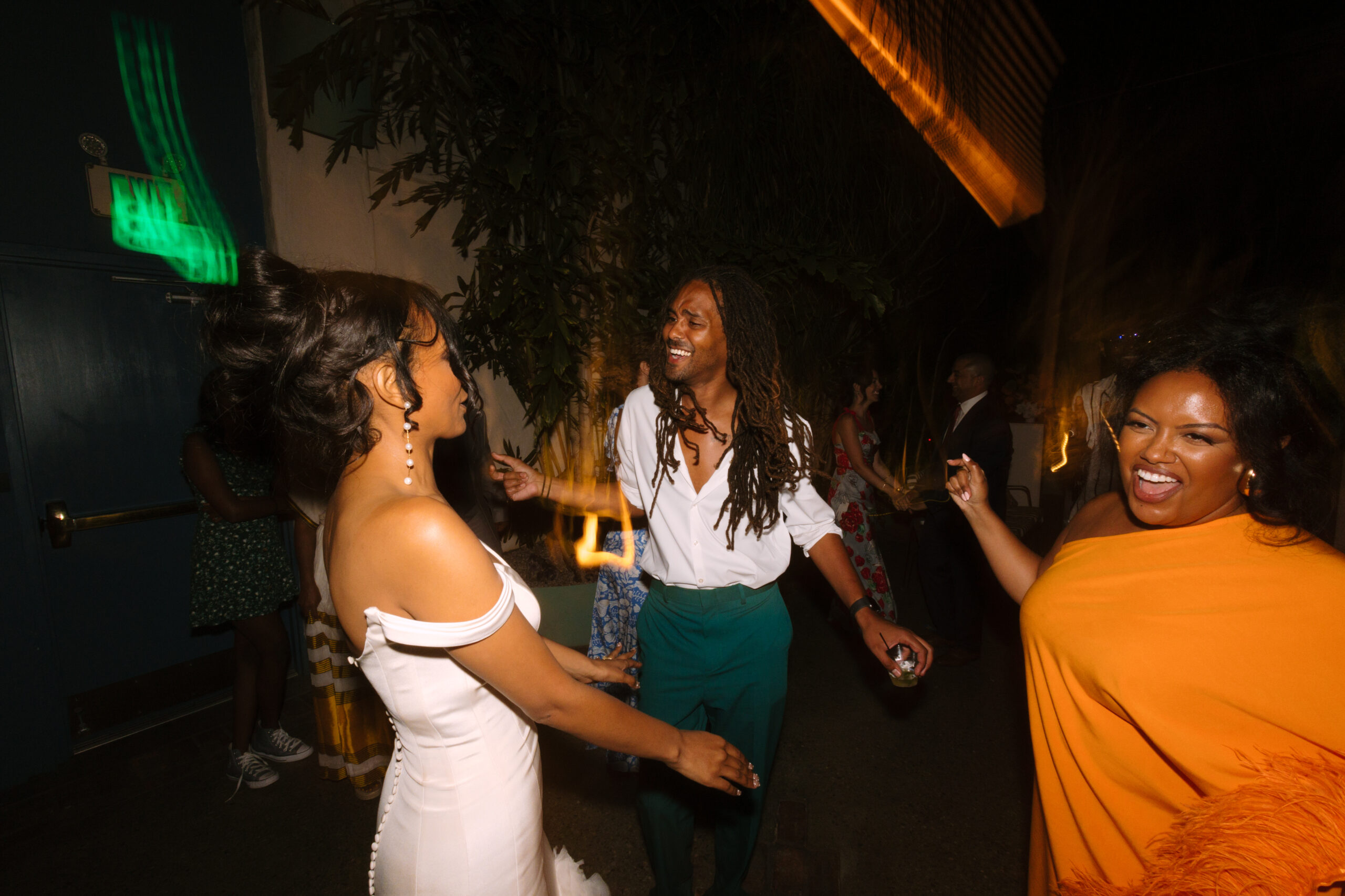 shutter drag flash photo of guests dancing with bride during reception at Grass Room DTLA