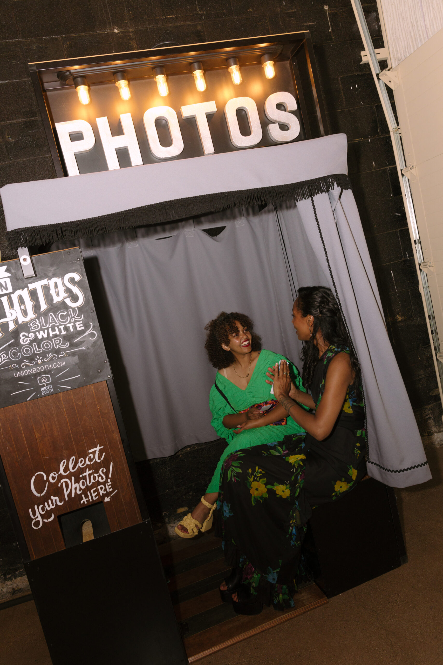 wide flash photo of guests laughing in photo booth during wedding reception at the Grass Room DTLA