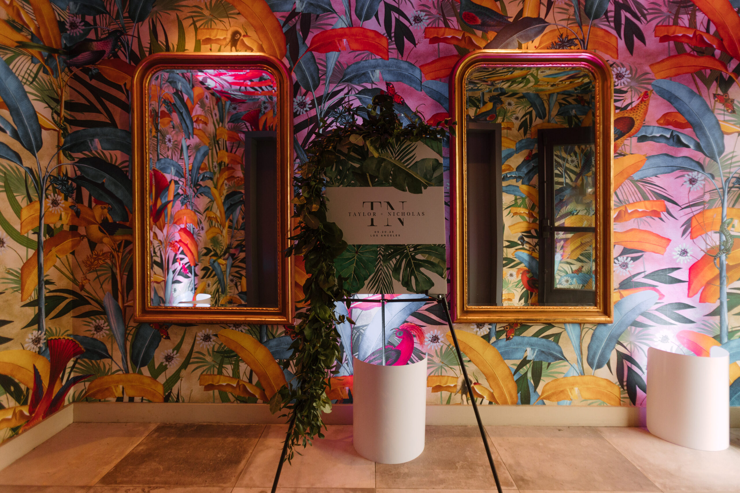 colorful tropical wallpaper and gilded mirrors in hallway on rooftop of Kimpton La Peer Hotel