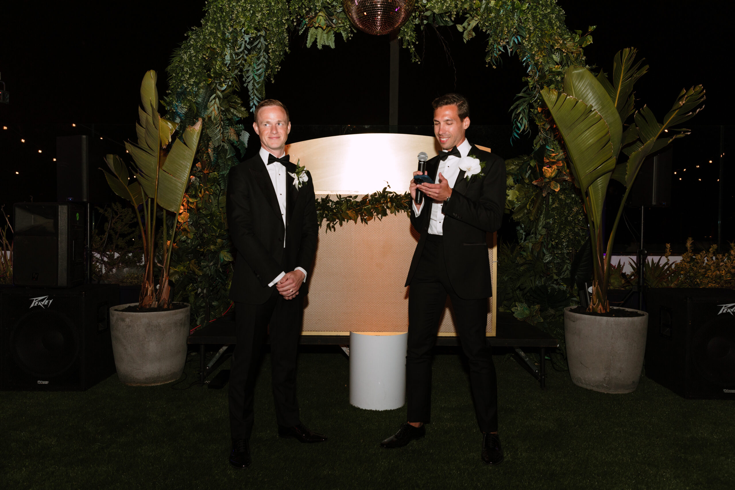 direct flash photo on Kimpton La Peer rooftop of gay grooms exchanging their wedding vows