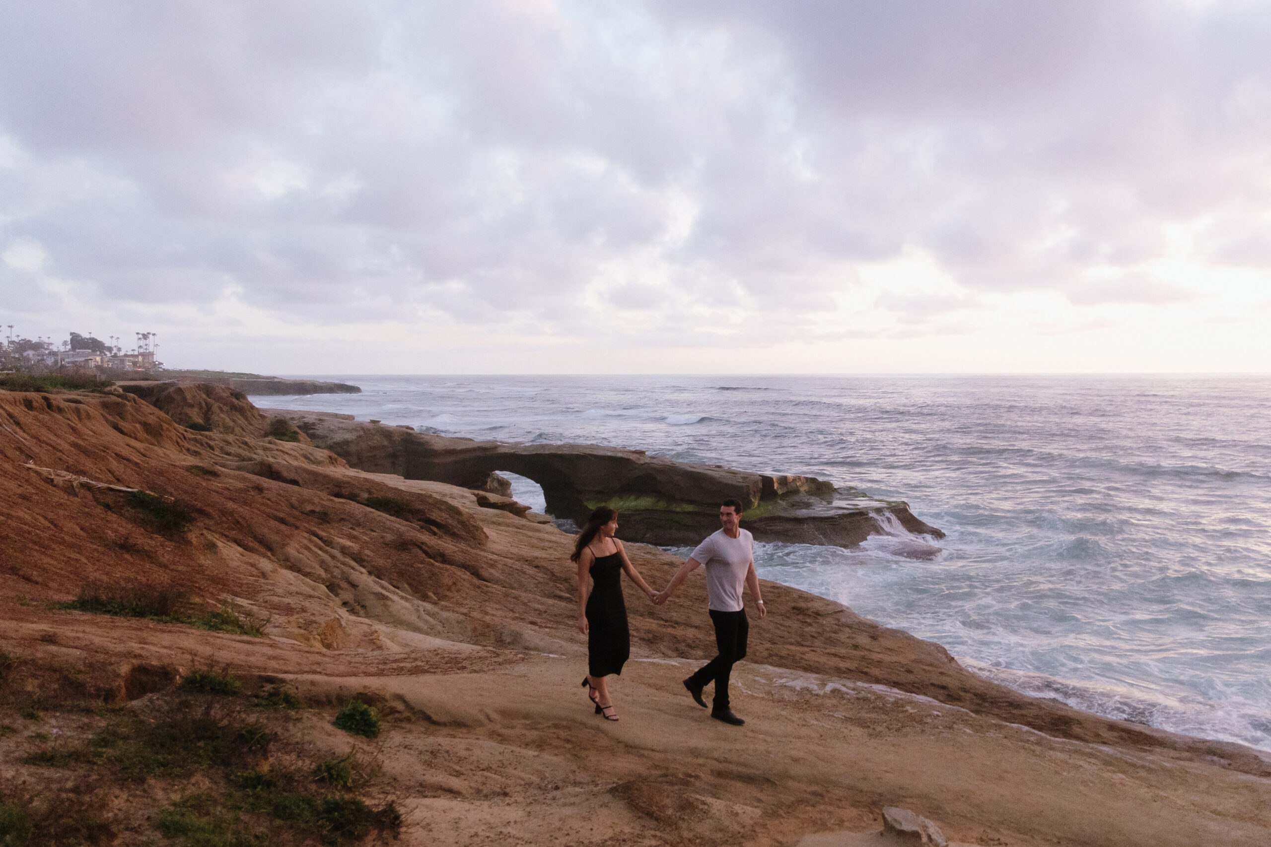 film photo of couple walking along Sunset Cliffs at blue hour