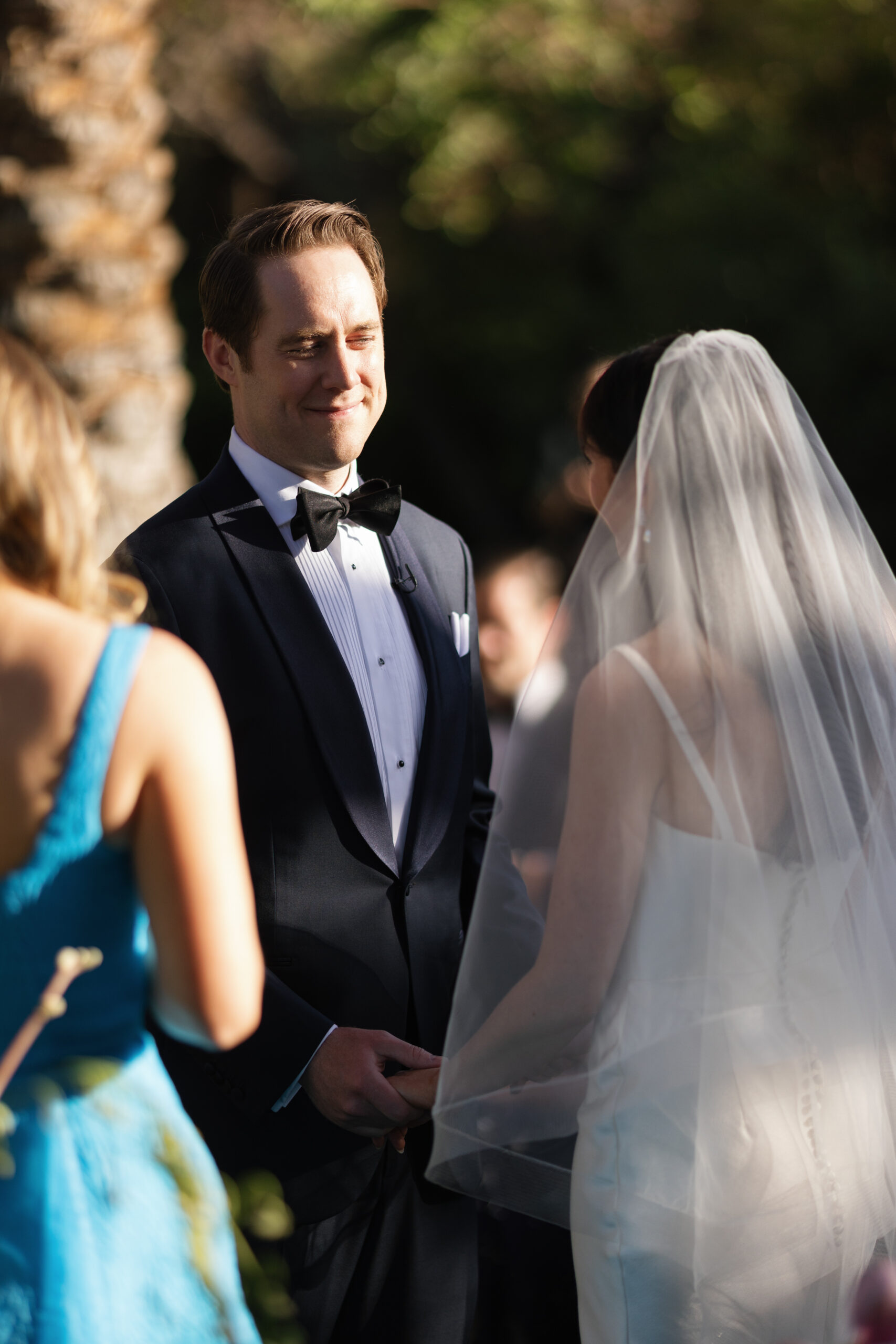 groom holding bride's hands during ceremony at Parker Palm Springs