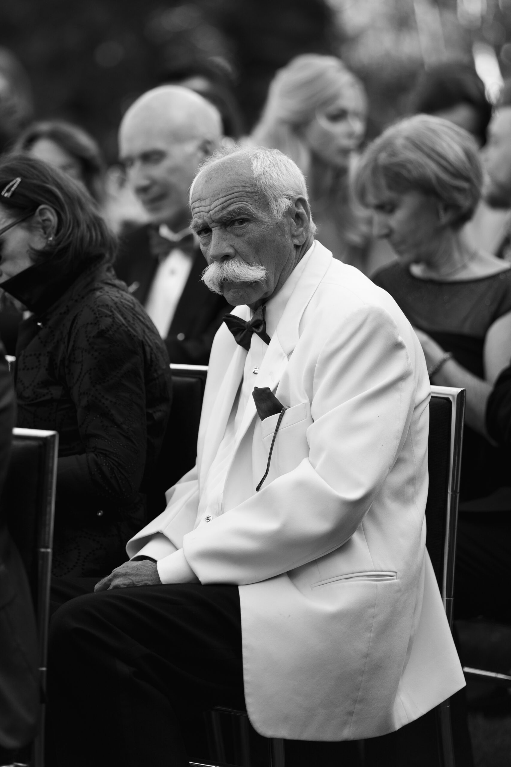 black and white photo of guest with mustache at ceremony at Parker Palm Springs