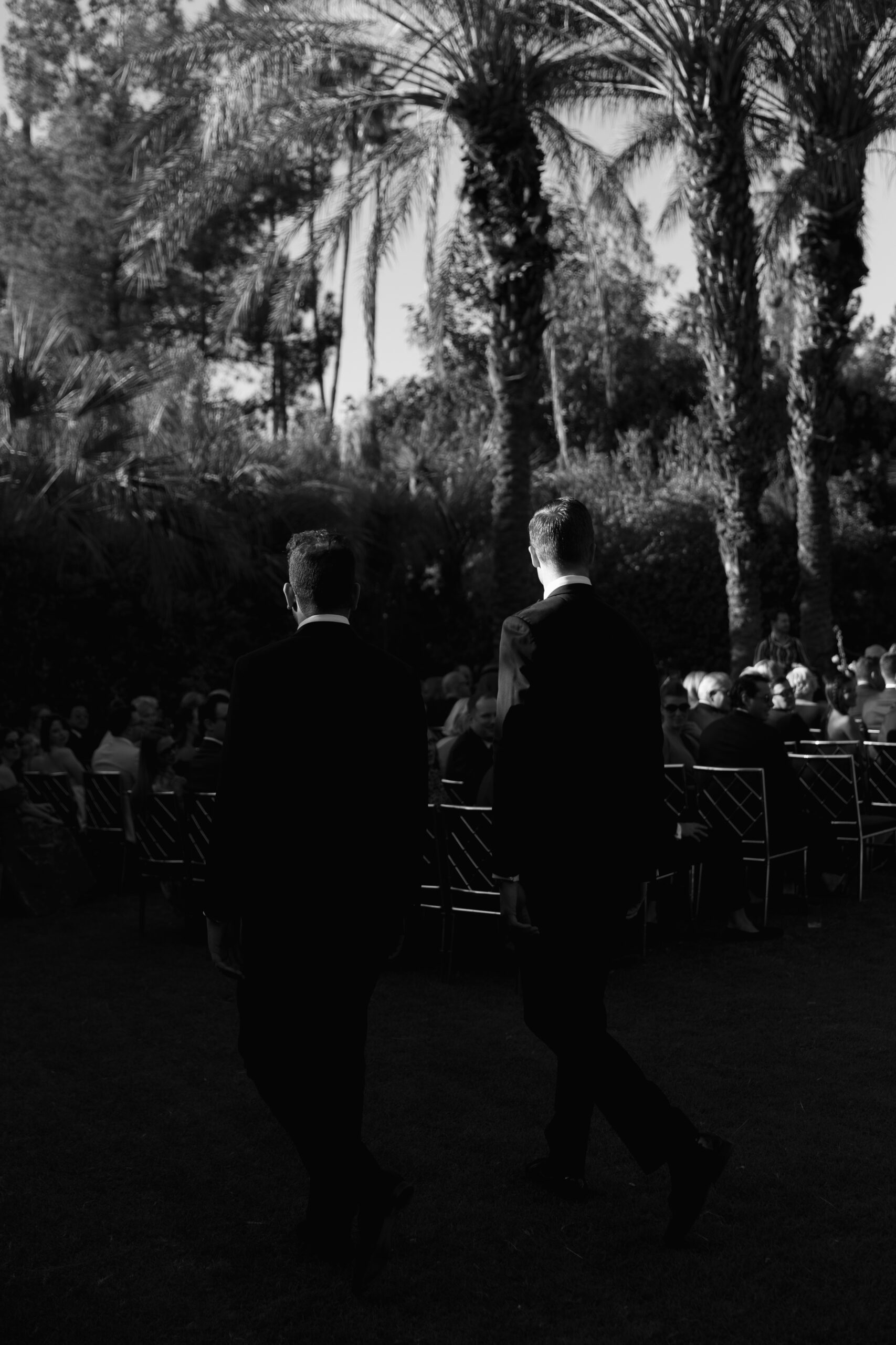 groomsmen from behind walking into ceremony on Palm Court at Parker Palm Springs