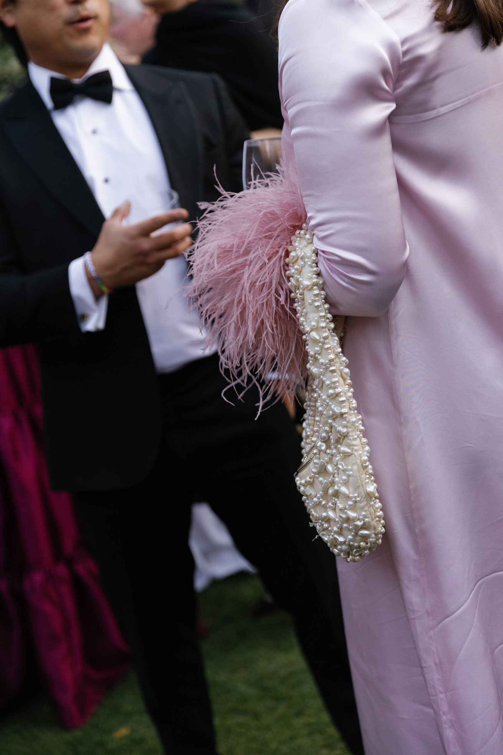 close-up of wedding guest attire and pearl clutch at Parker Palm Springs cocktail hour