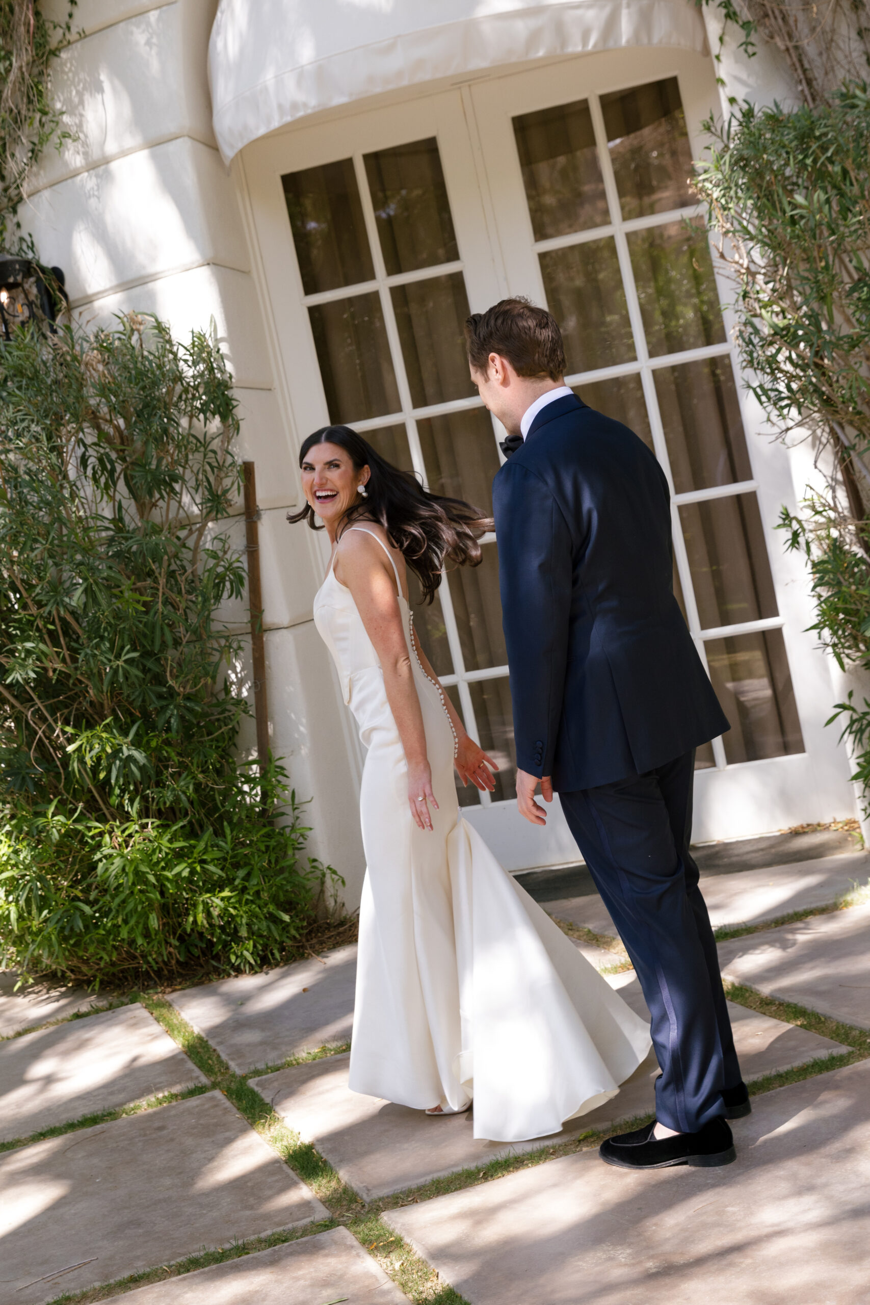 bride twirling in her dress in front of the Mafia Suite at Parker Palm Springs