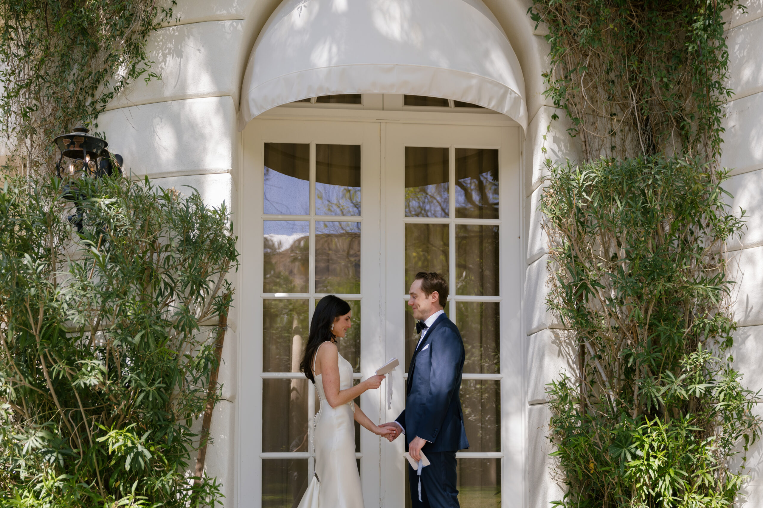 bride and groom sharing private vows in front of the Mafia Suite at Parker Palm Springs