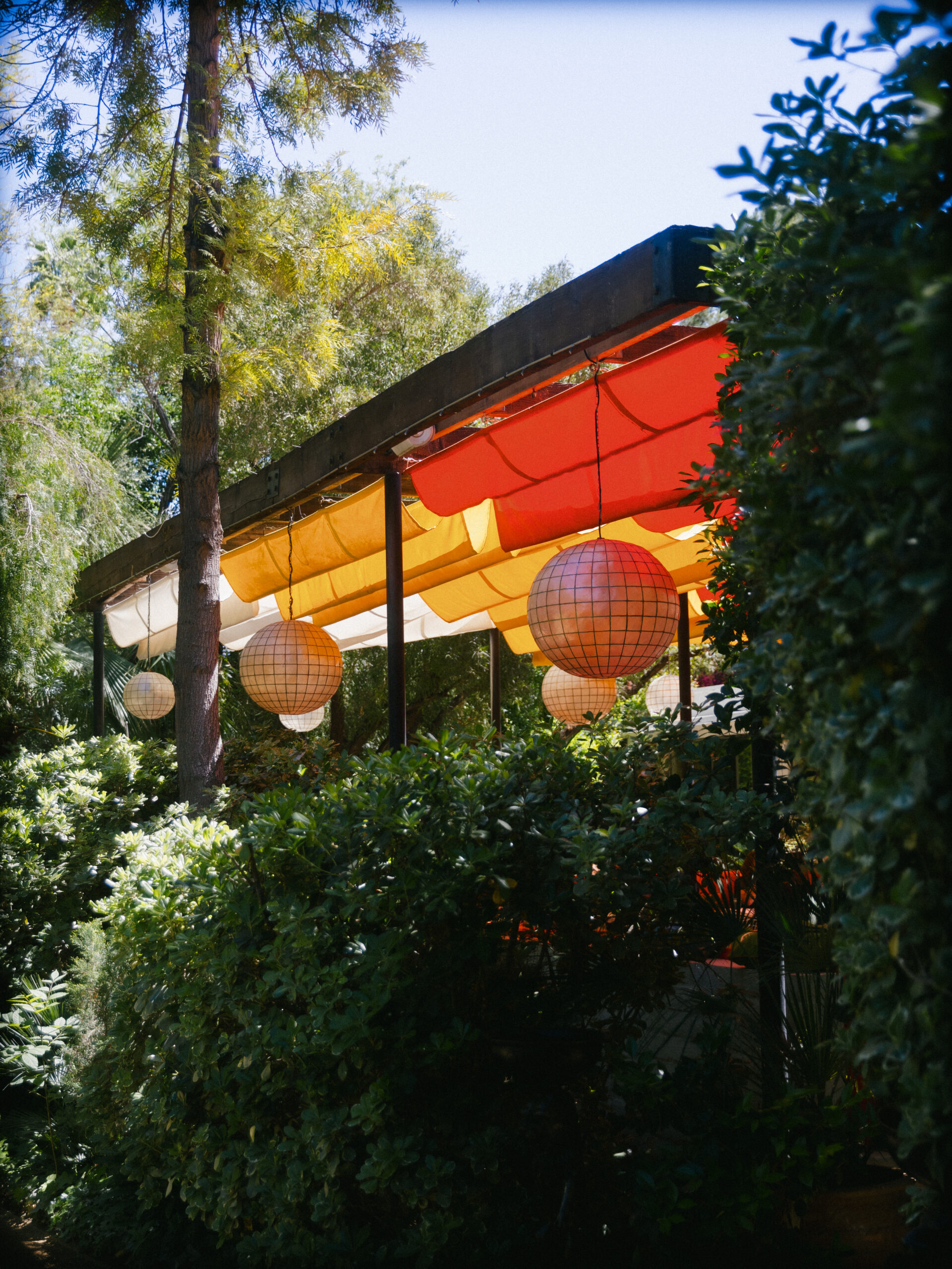 film photo of Parker Palm Springs restaurant orange and yellow canopy and light fixtures