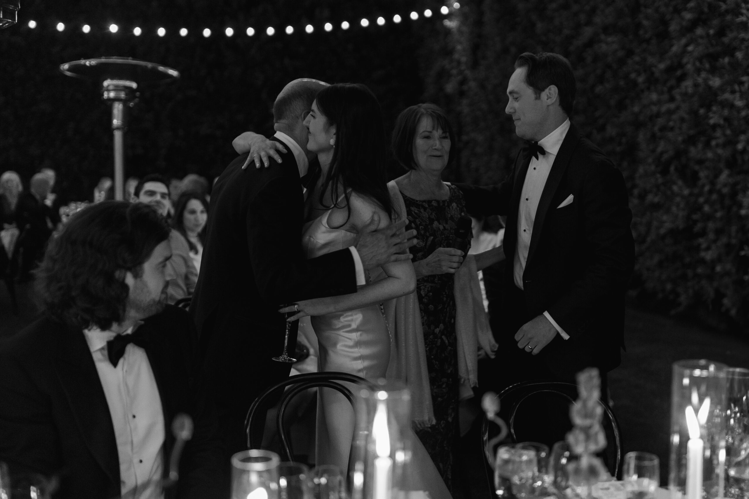 black and white photo of bride hugging dad after toast on banquet lawn at Parker Palm Springs