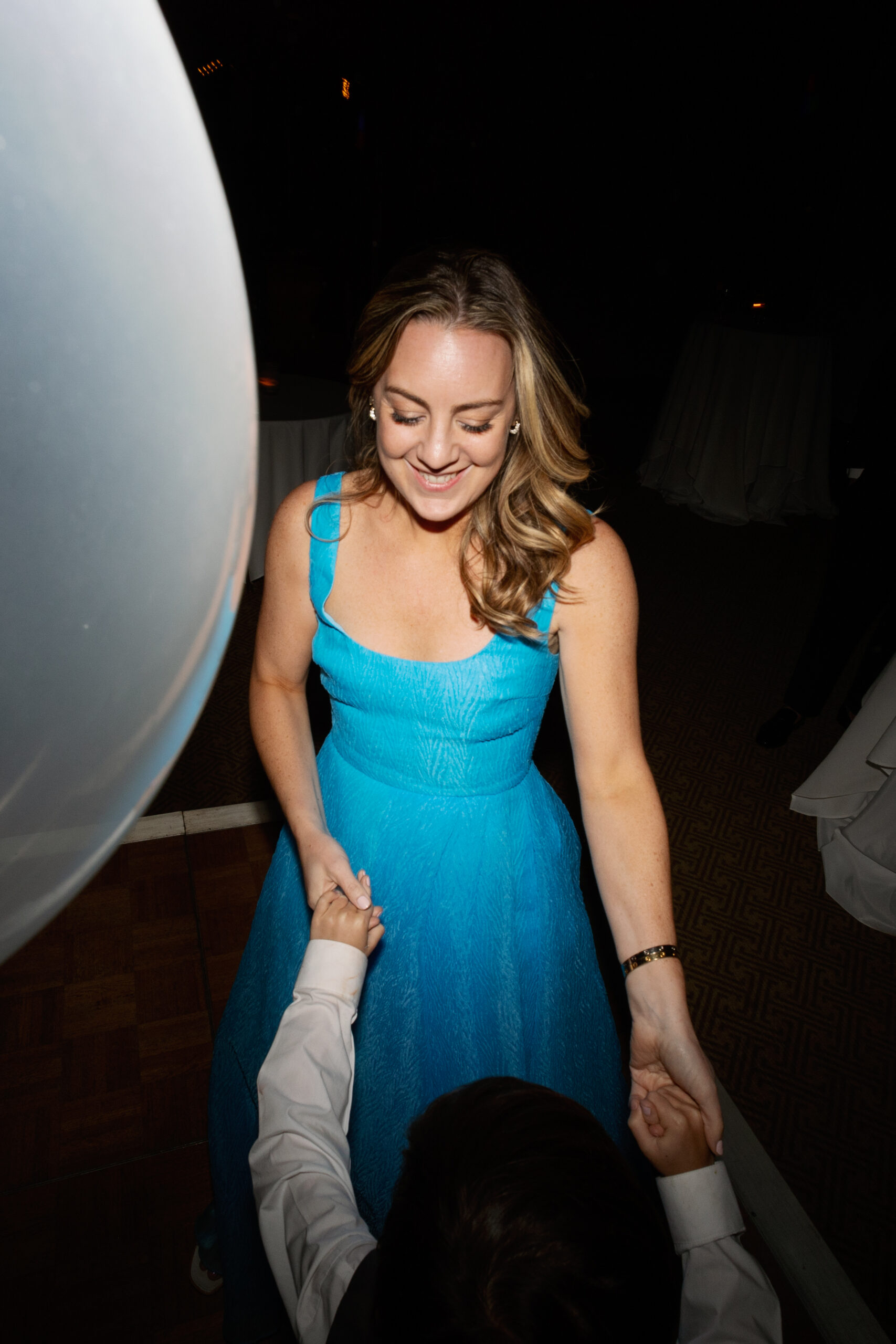 flash photo of mom and child dancing during reception