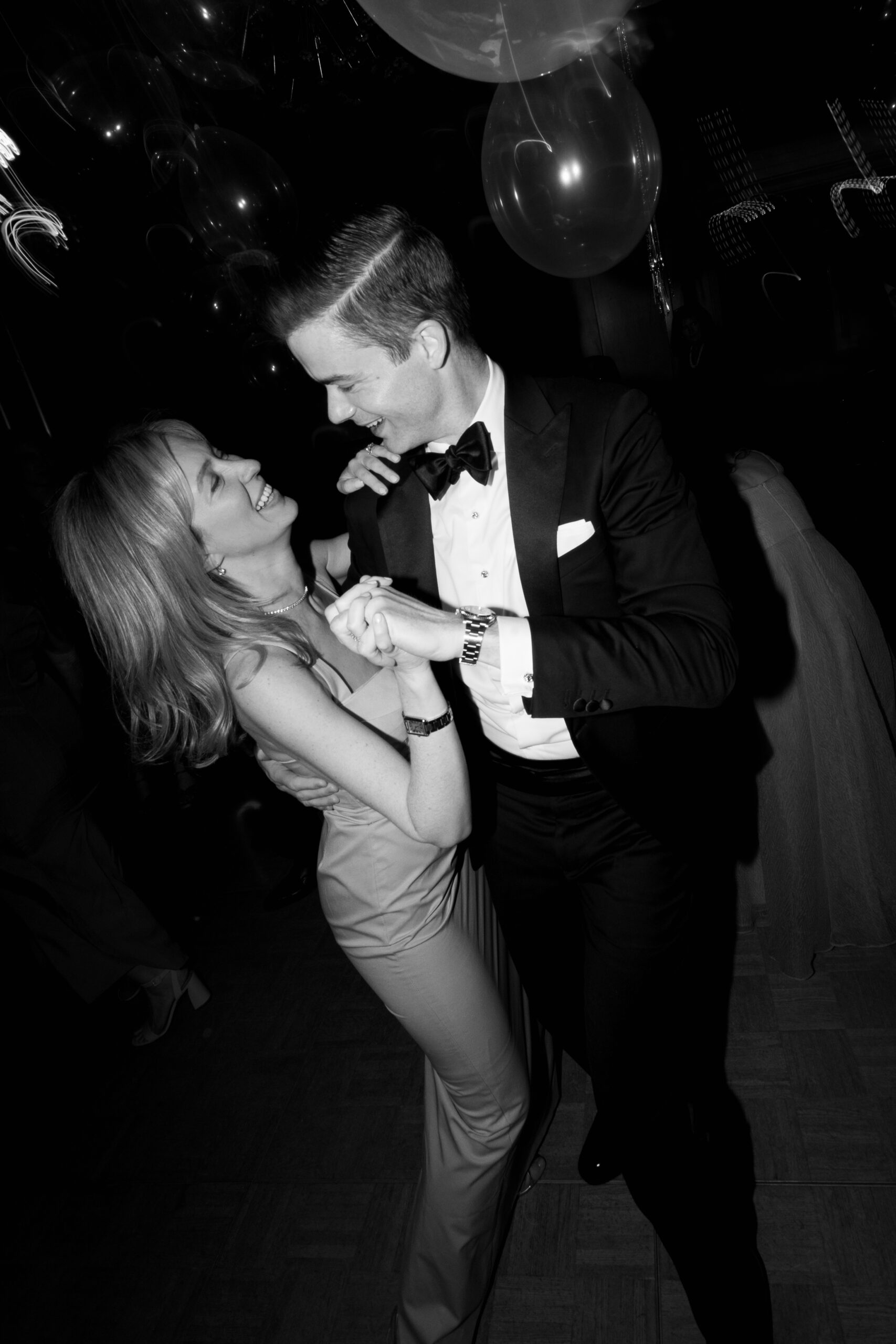 black and white flash photo of guest and wife dancing during reception at Parker