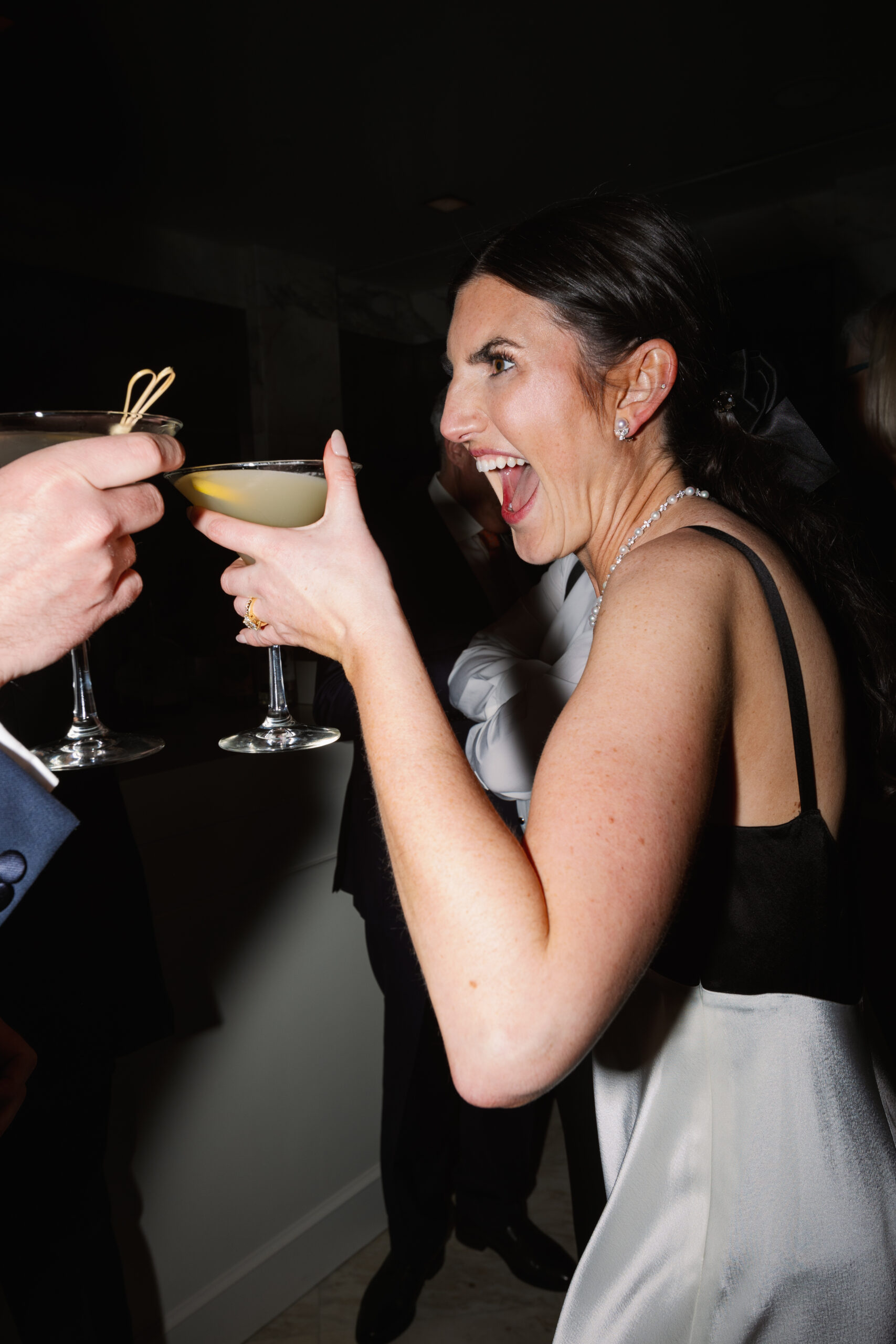 flash photo of bride toasting with lemon drop at reception