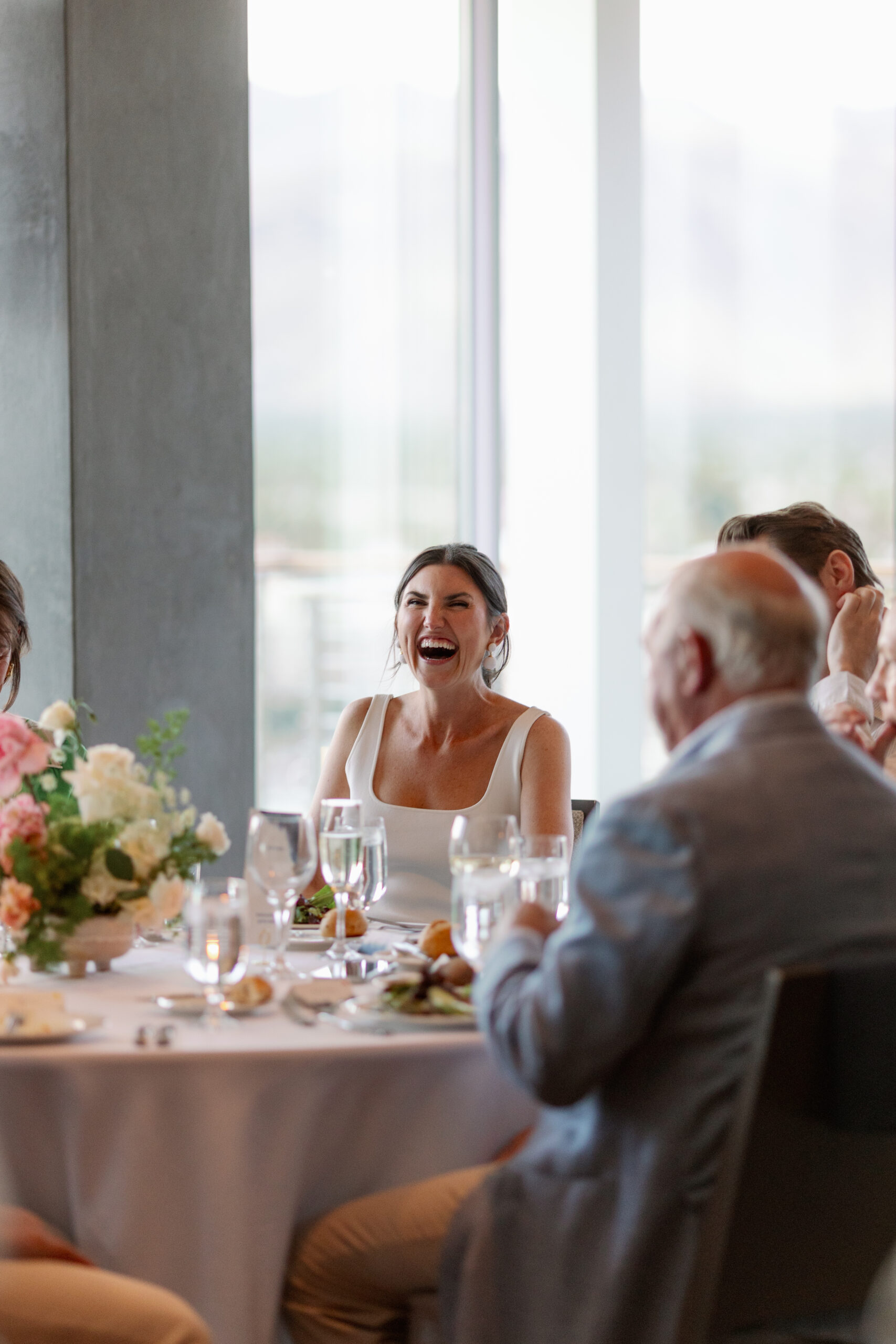 bride laughing during rehearsal dinner in Kimpton Rowan Jacinto Room