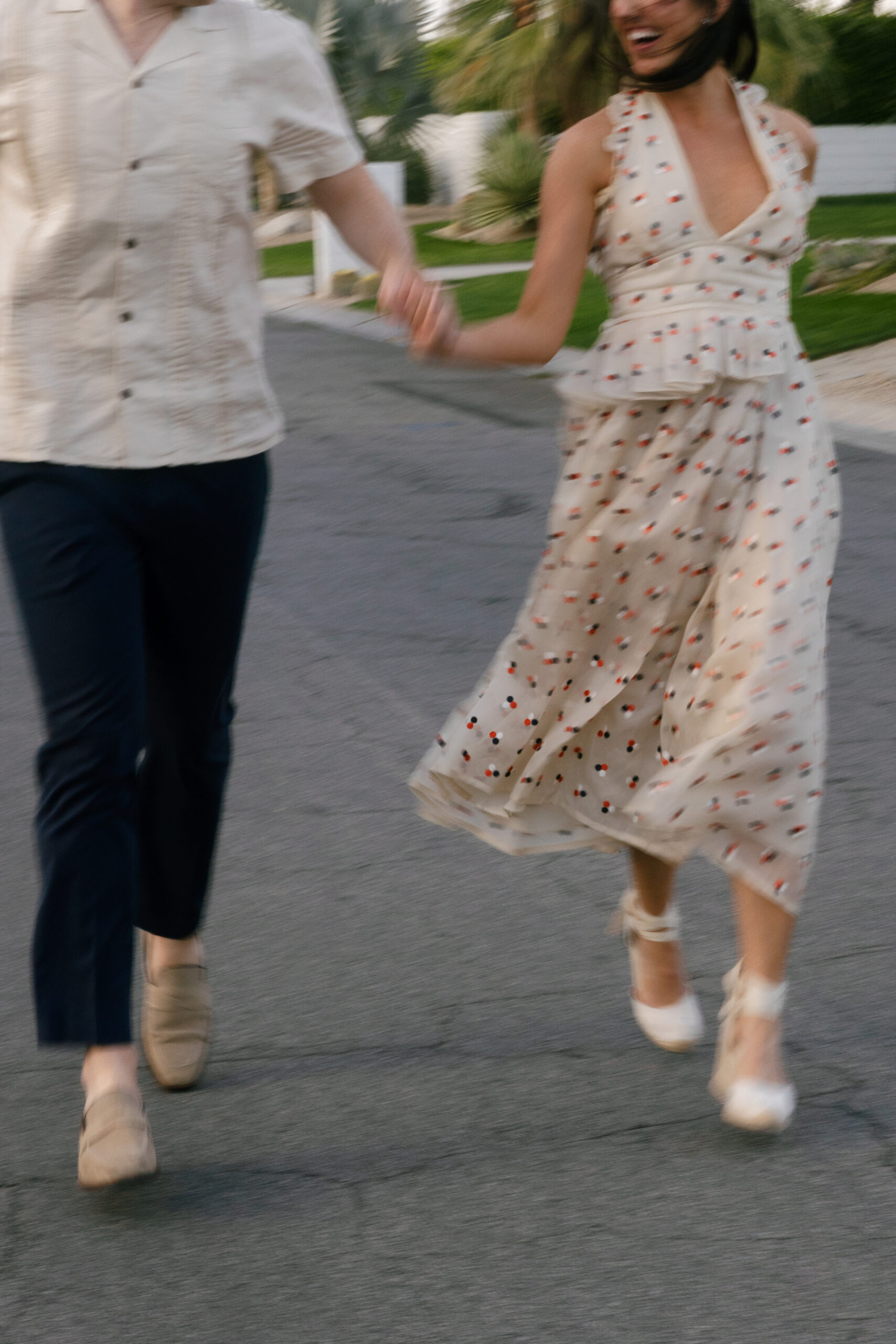 blurry image of couple running down street in Palm Springs neighborhood