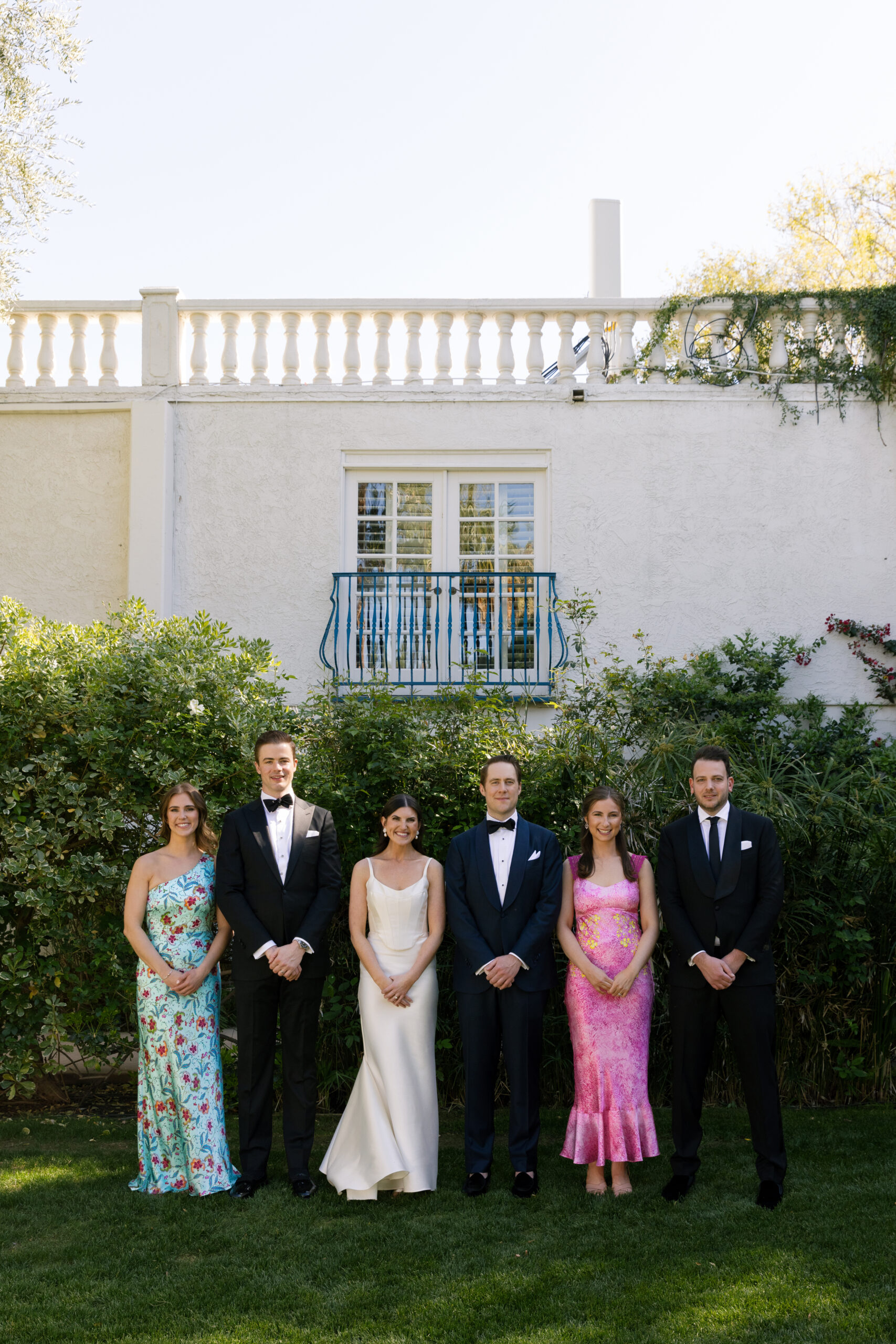 wedding party posing for formal photo on croquet lawn at Parker Palm Springs